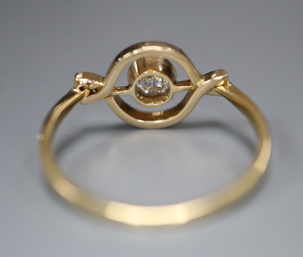 An 18ct and solitaire diamond set ring, in openwork setting, size M, gross 2.2 grams.